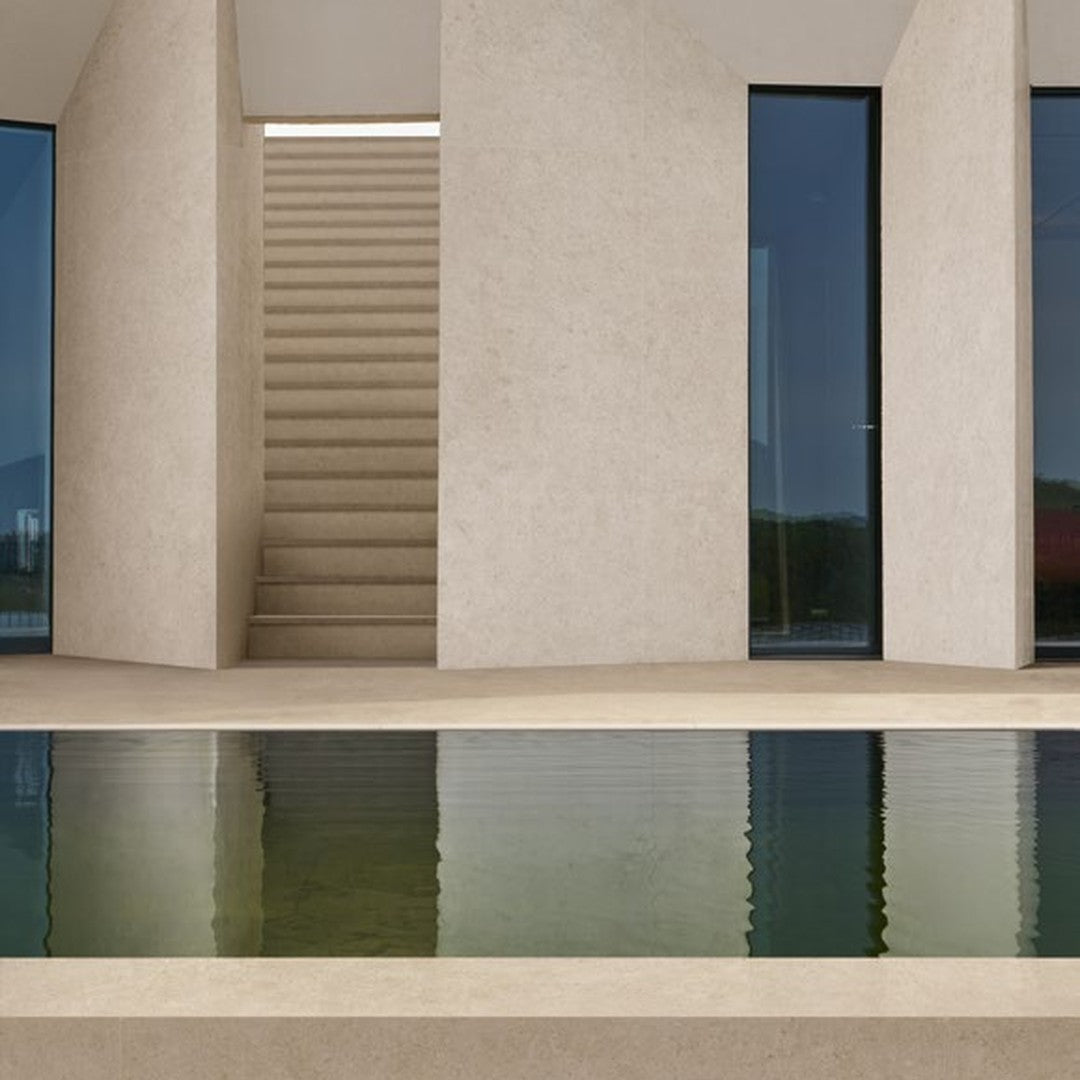 Boost Stone Cream stone-effect porcelain tile at a private villa pool terrace