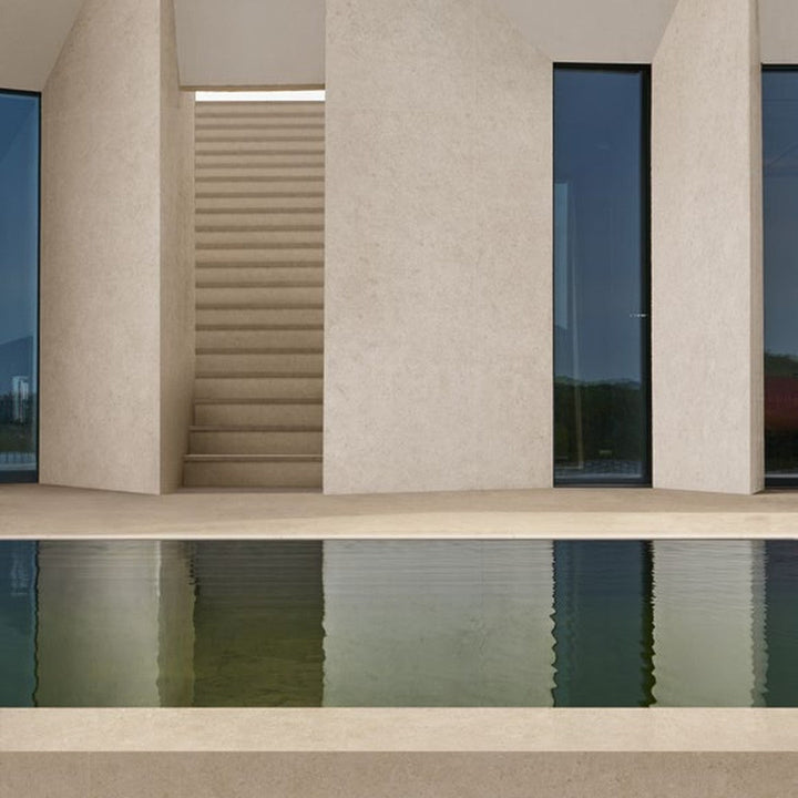 Boost Stone Cream stone-effect porcelain tile at a private villa pool terrace