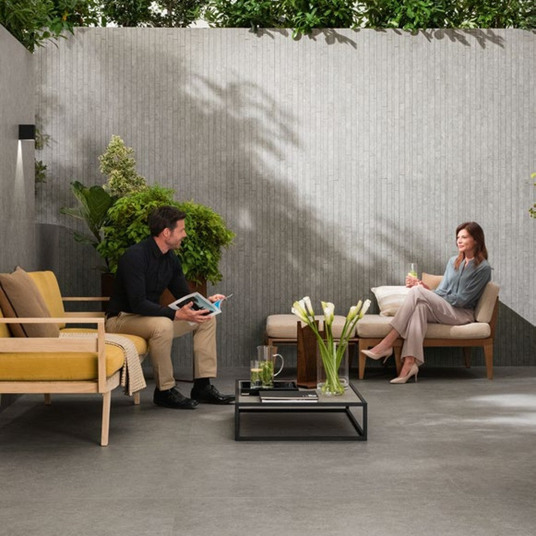 Boost Stone Grey stone-effect porcelain wall and floor tile on an outdoor terrace