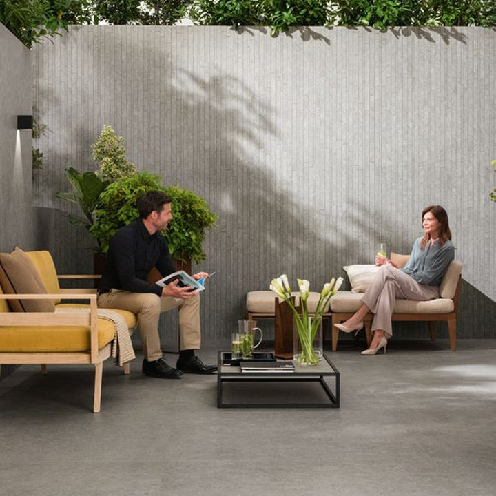 Boost Stone Grey stone-effect porcelain wall and floor tile on an outdoor terrace