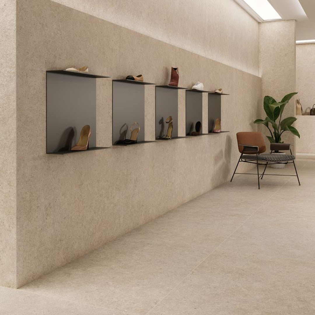 Boost Stone Ivory stone-effect porcelain wall and floor tile in a fashion showroom