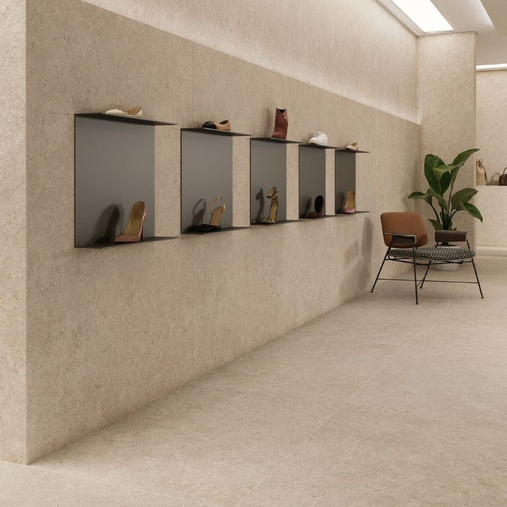 Boost Stone Ivory stone-effect porcelain wall and floor tile in a fashion showroom