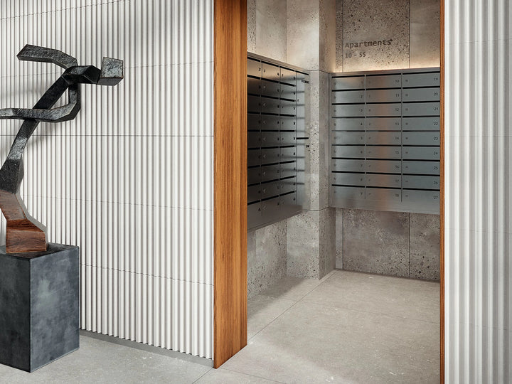 Plinth Off Stone 3D ceramic wall tile shown in a room setting